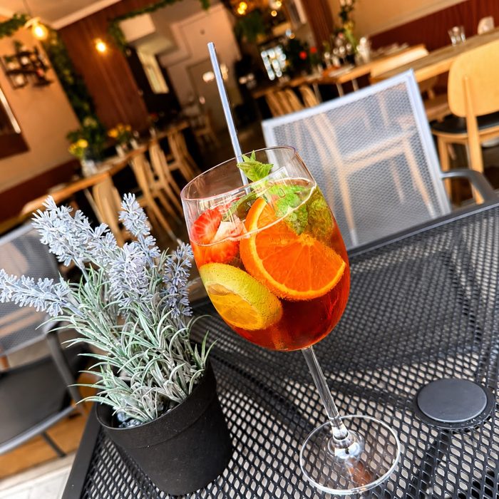 Orange spritz garnished with orange, lime and strawberry at Musti's Grill & Bistro