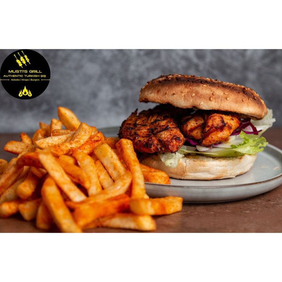 Grilled chicken burger with seasoned chips at Musti's Grill & Bistro