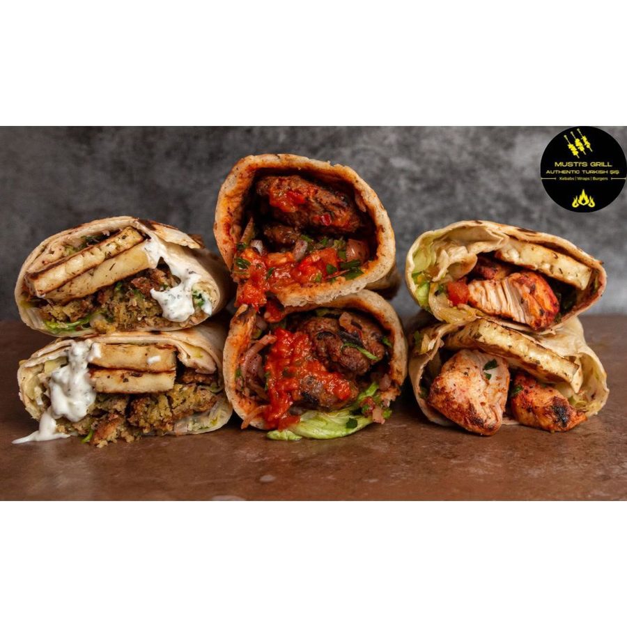 Selection of three cut wraps showing falafel, kofte and chicken fillings at Musti's Grill & Bistro